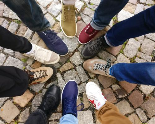 Shoes worn by a group of people standing in a circle
