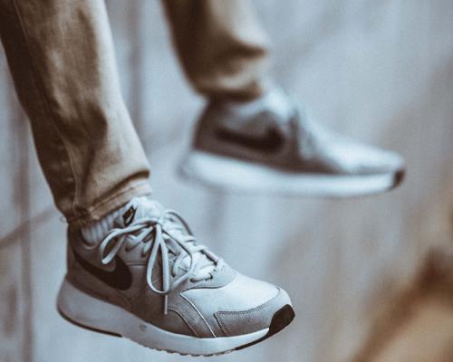 A person lacing up a new pair of shoes