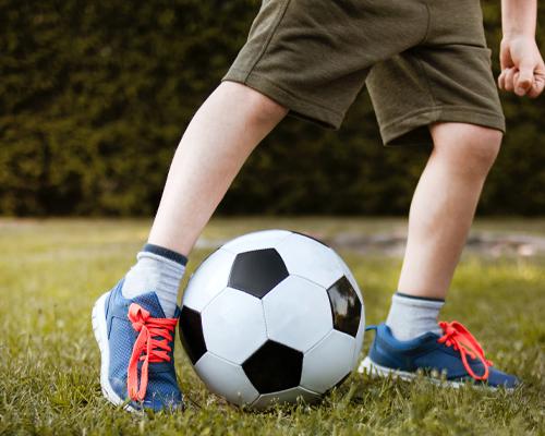 A child playing soccer in new shoes